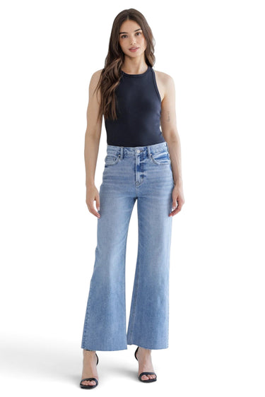 Model wearing SaltTree Mica Denim super high rise wide leg jeans in medium blue wash with a raw hem