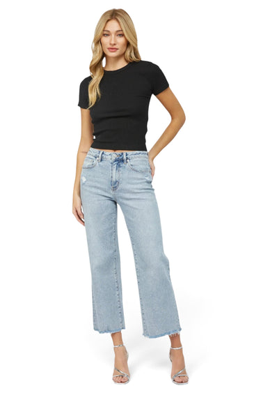 SaltTree model wearing Mica Denim high-rise wide-leg jeans in icy light blue wash with a raw hem and distressed detail