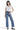 SaltTree model wearing Mica Denim high rise wide leg jeans in medium blue with a distressed raw hem and white top.