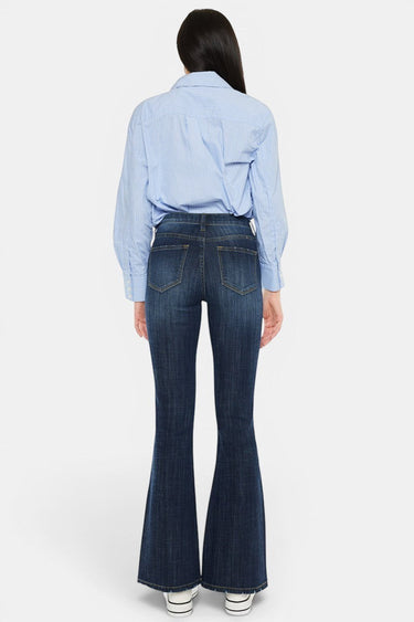 SaltTree Mid Rise Flare Petite Jeans in dark wash denim with whiskering and fading. Features contrast stitching and a 31.75" inseam.