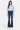 SaltTree Mid Rise Flare Petite Jeans in dark wash denim with whiskering and fading. Features contrast stitching and a 31.75" inseam.