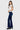 SaltTree model wearing ONE HUNDRED B high rise dark denim bootcut jeans with a white collared shirt and black heels