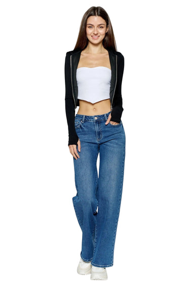SaltTree model wearing ONE HUNDRED B high rise relaxed wide leg jeans in medium denim with stone wash and whiskers