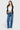 SaltTree model wearing ONE HUNDRED B high rise relaxed wide leg jeans in medium denim wash with whiskering.