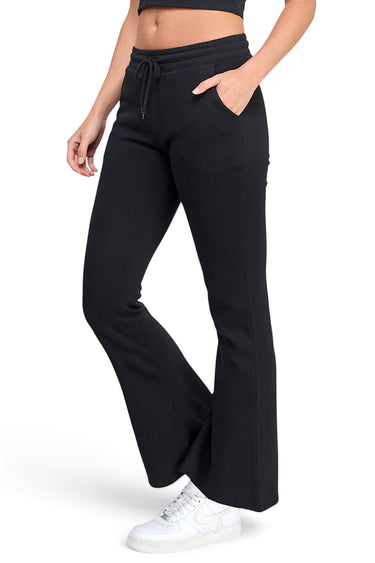 SaltTree Reflex black fleece flare joggers with an elasticized drawstring waist and side pockets on a model
