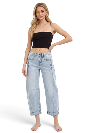 SaltTree model wearing Risen Jeans high-rise light wash barrel denim with cuffed hems and curved side seams.