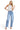 SaltTree model wearing Risen Jeans high-rise medium indigo barrel denim with cuffed hems and curved side seams.