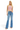 SaltTree model wearing Risen Jeans high-rise flare denim with tummy control in a medium indigo wash.
