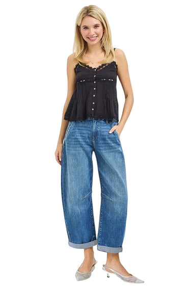 SaltTree model wearing Risen Jeans medium wash high-rise slouchy barrel jeans with a cuffed hem and black lace top.