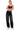 SaltTree model wearing Wax Jean black sand wash balloon wide leg denim jeans with a purple camisole top