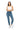 SaltTree model wearing Wax Jean high-rise skinny denim jeans in medium blue with a white crop top and sneakers