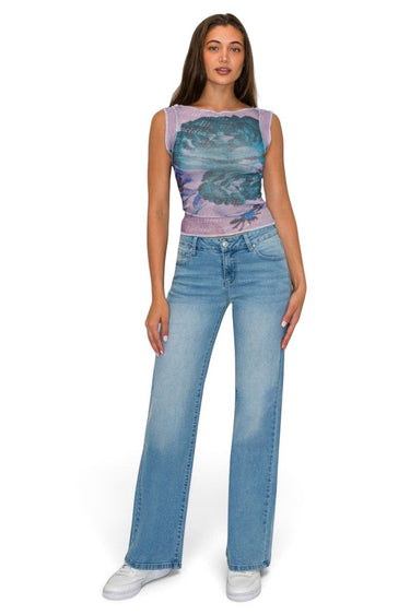 SaltTree model wearing Wax Jean medium blue low-rise fitted wide leg jeans with a 31-inch inseam and comfort stretch.