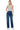 SaltTree model wearing Wax Jean mid-rise straight-leg jeans in medium blue sketch wash denim with a grey tank top