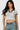SaltTree model wearing a white Love Poem cropped polo top with black contrast collar and sleeves in seamless fabric.