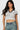 SaltTree model wearing a white Love Poem cropped polo top with black contrast collar and sleeves in seamless fabric.