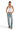 SaltTree model wearing a white ribbed V-neck camisole with adjustable straps and light-wash embellished denim jeans.