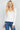 SaltTree model wearing a white Active Basic V-neck button-front cardigan in a soft viscose-nylon stretch blend.