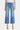 SaltTree medium wash high rise slim wide leg cropped jeans with raw hem and light distressing. Cotton blend.