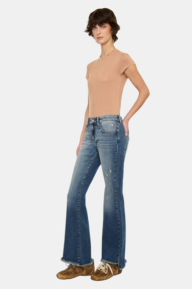 SaltTree dark wash low rise ankle flare jeans with uneven frayed hem and light distressing. Model wears size 5/26.