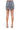 SaltTree American Bazi black wash denim mini skirt with back pockets, worn by a model with beige heeled sandals.