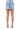 SaltTree American Bazi light blue denim mini skirt with back pockets, worn by a model in nude heels