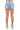 SaltTree American Bazi light blue denim cargo mini shorts viewed from the back on a model wearing white sneakers