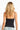 SaltTree ANWND black camisole top with adjustable spaghetti straps worn by a blonde model, back view