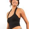 SaltTree ANWND black sleeveless halter neck cropped tank top with a hanky hem worn by a smiling model