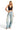 Model wearing SaltTree ANWND black ribbed seamless V-neck crop top with wide straps and light wash wide-leg jeans
