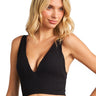 Model wearing a black SaltTree ANWND ribbed seamless crop top with a deep V-neckline and wide straps.