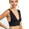 SaltTree ANWND black ribbed sleeveless crop top with a deep V-neckline worn by a model with light hair.