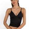 SaltTree ANWND black ribbed cropped camisole with a low V-neckline and adjustable spaghetti straps on a model.