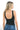SaltTree ANWND black ribbed tank bodysuit with a deep scoop back worn by a blonde model with blue denim jeans