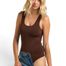 SaltTree model wearing a brown ANWND scoop neck sleeveless seamless bodysuit with denim jeans