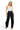 SaltTree model wearing a white ANWND seamless bustier crop top with black high-waisted trousers