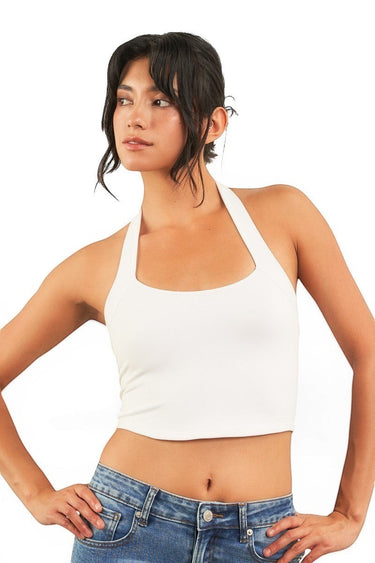 Model wearing a white SaltTree ANWND halter neck cropped tank top with a sleeveless fitted silhouette.