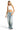 SaltTree model wearing an ANWND white high neck seamless crop top with light wash baggy jeans