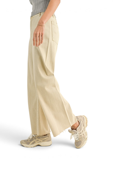 SaltTree Miou Muse high-rise wide-leg crop pants in beige stretch twill with a raw hem, worn with sneakers.
