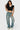 Model wearing SaltTree black cropped polo top with white contrast collar and sleeves, styled with high-rise denim jeans.