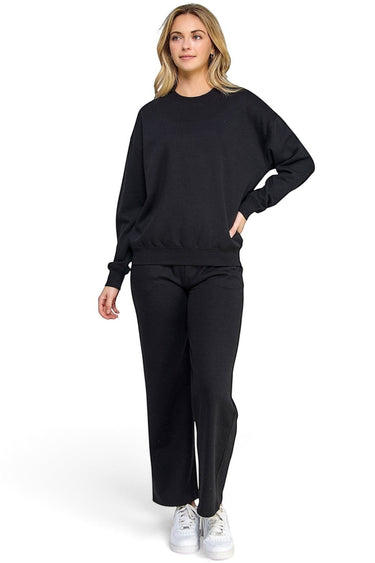 Model wearing a SaltTree black fleece crew neck sweatshirt with a relaxed fit and ribbed trims, paired with matching pants.