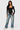 SaltTree model wearing a black Love Poem long sleeve scoop neck bodysuit with blue denim jeans