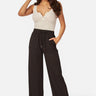 SaltTree model wearing black ribbed knit wide-leg pants with an elastic drawstring waist and side pockets