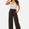 SaltTree model wearing black ribbed knit wide-leg pants with an elastic drawstring waist and side pockets
