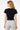 Model wearing a black SaltTree short sleeve knit cardigan with a round neckline and fitted waist, back view.