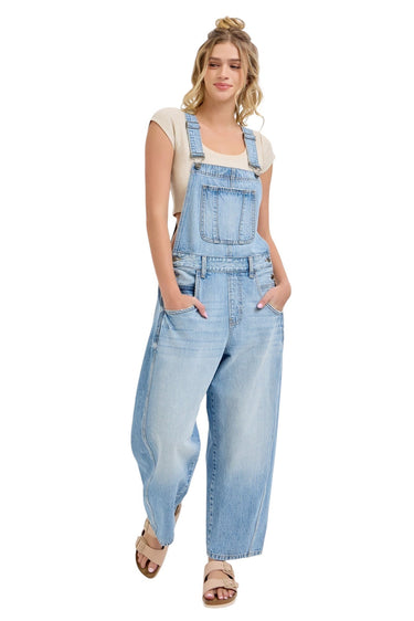 SaltTree model wearing Cello Jeans light wash cotton barrel leg denim overalls with a square neck and racerback.