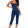 Model wearing a SaltTree DIOSA dark wash denim corset jumpsuit with a sweetheart neckline and skinny capri legs.
