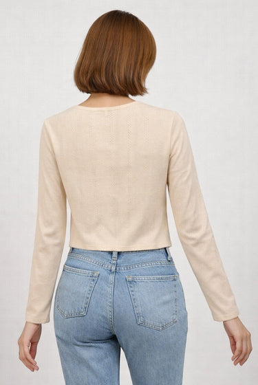 SaltTree Dreamers off-white ribbed knit long sleeve cropped cardigan with scalloped edges worn with light blue jeans.
