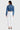 SaltTree model wearing Enjean cropped destructed denim jacket in medium wash with white jeans, back view