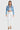 SaltTree Enjean cropped denim jacket in light stone wash with destructed details worn by a model with white pants