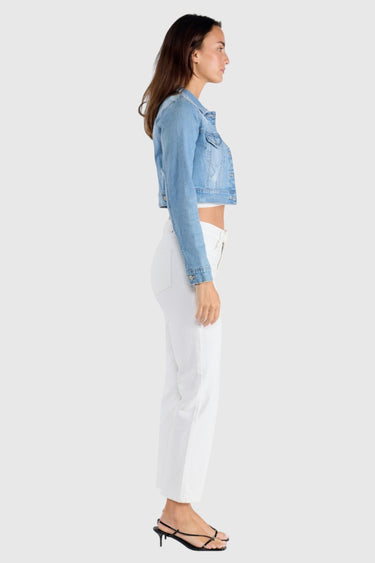 SaltTree model wearing Enjean light wash cropped denim jacket with destructed details and white jeans, side profile